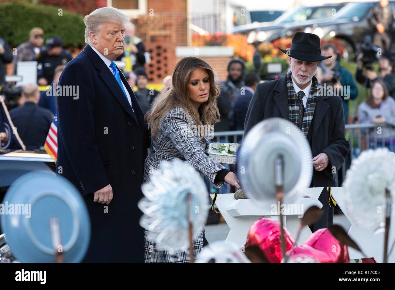 U.S first lady Melania Trump, place a stone from the White House on the memorial of those killed at the Tree of Life Synagogue as President Donald Trump and Rabbi Jeffrey Myers, right, look on October 30, 2018 in Pittsburgh, Pennsylvania. Stock Photo