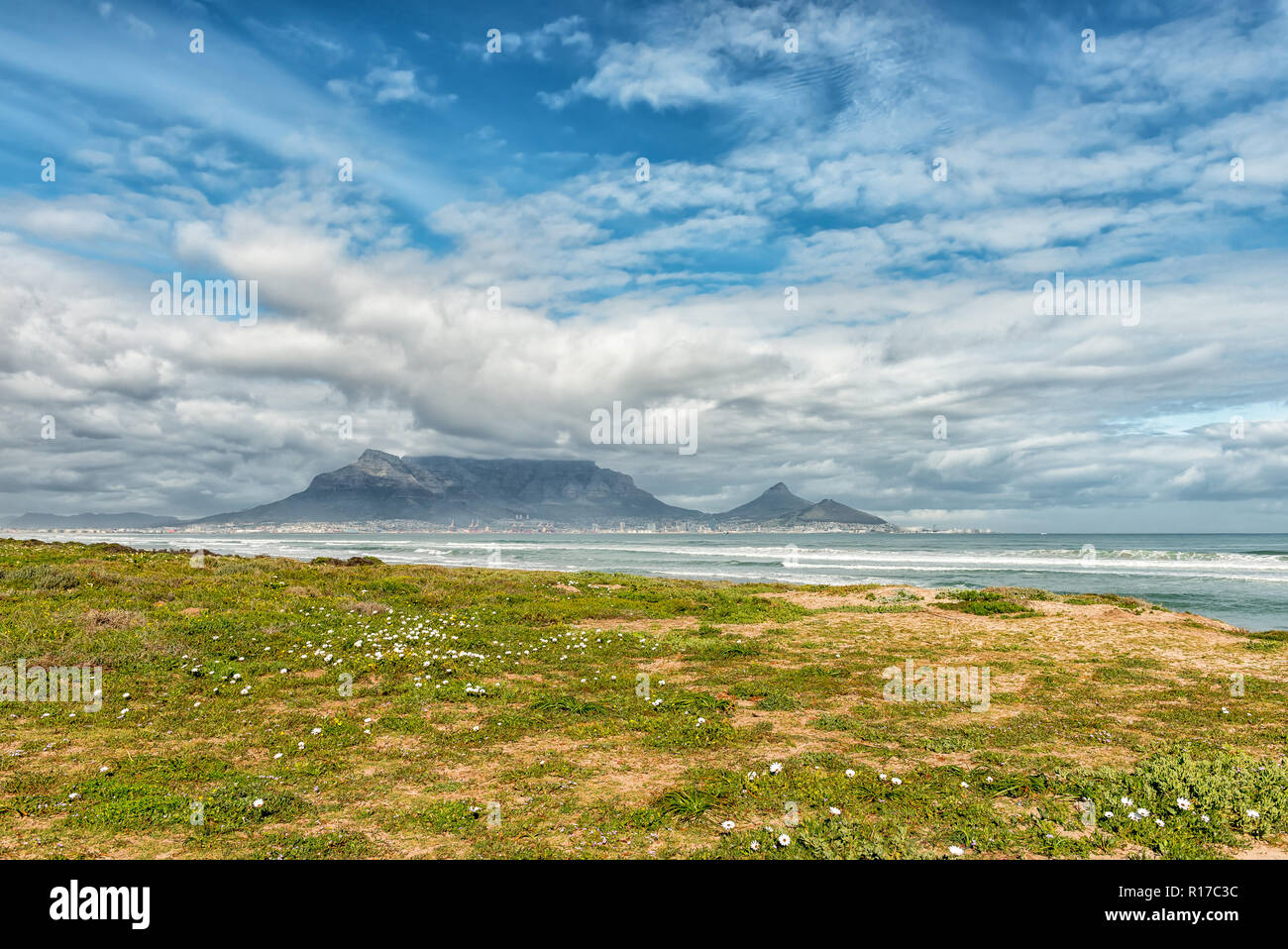 The Cape Town Central Business District and Table Mountain as seen across Table Bay from Dolphin Beach in Bloubergstrand Stock Photo