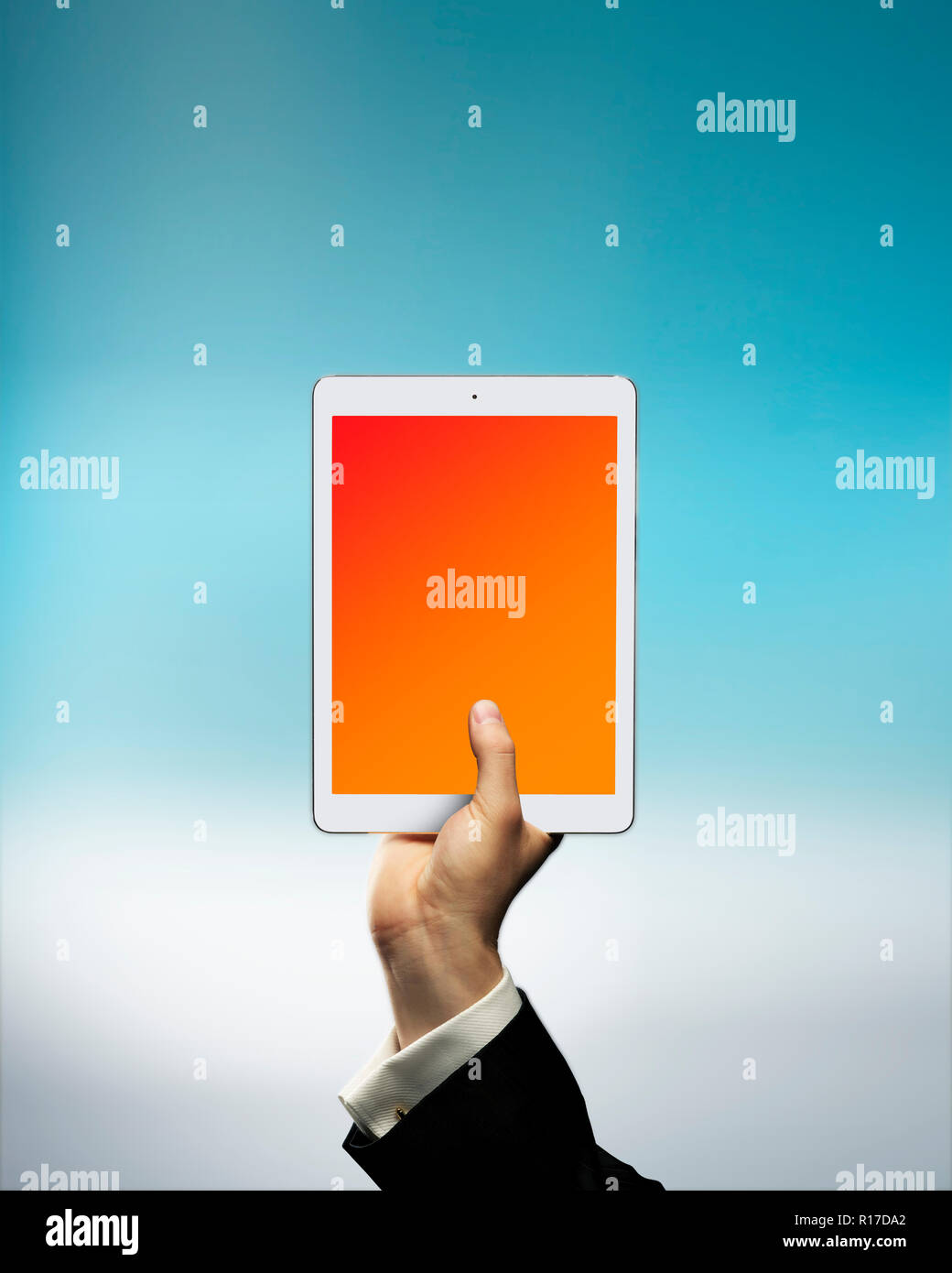 Businessman's hand holding digital tablet above cloud, cloud storage Stock Photo