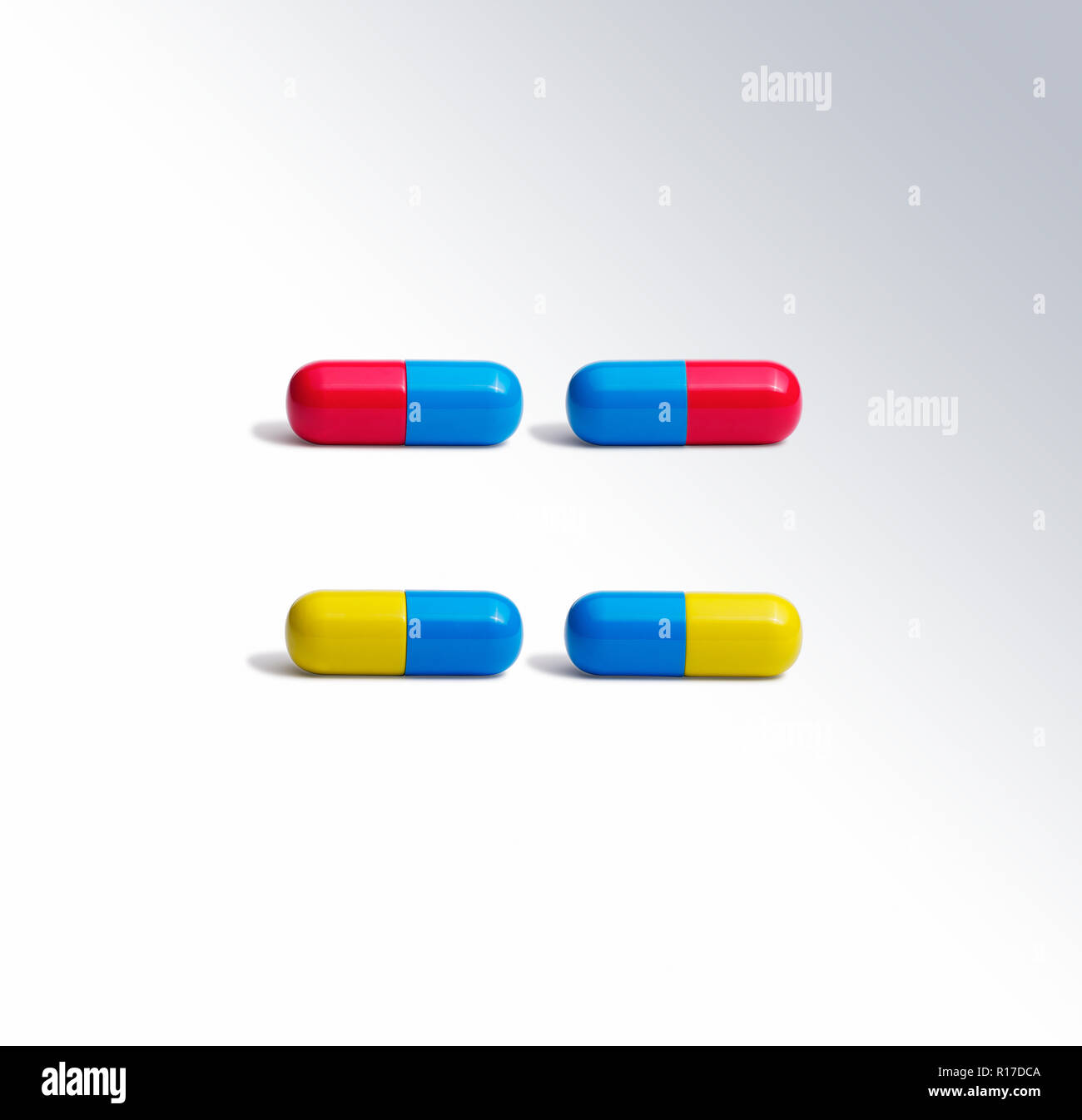 Four colourful medication pill capsules side by side, still life Stock Photo