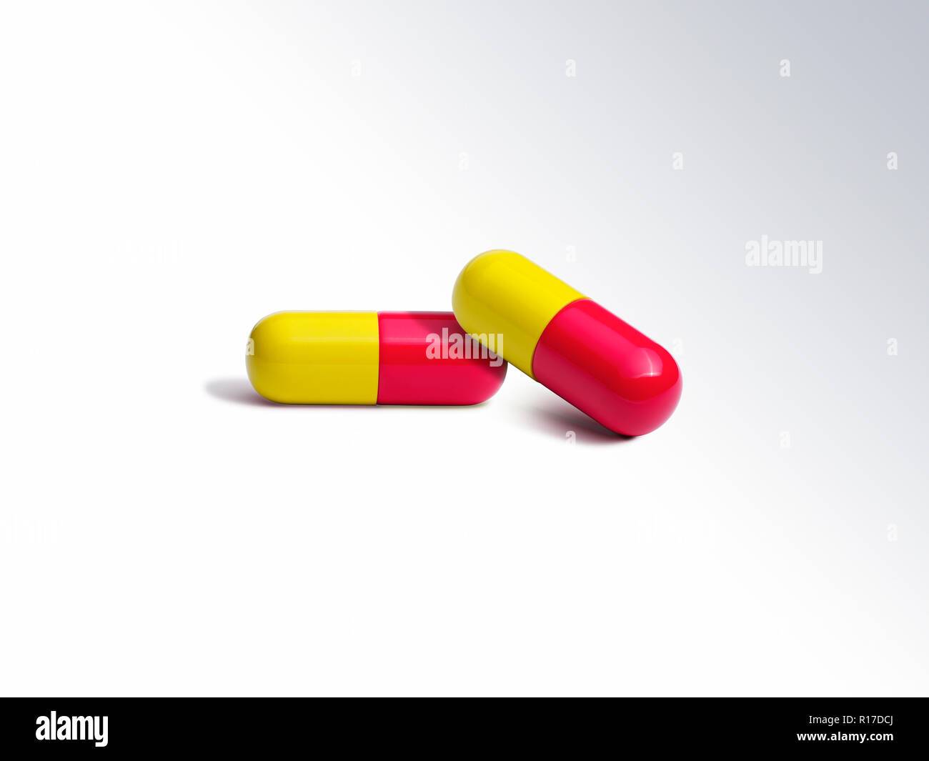 Two red and yellow medication pill capsules, still life Stock Photo