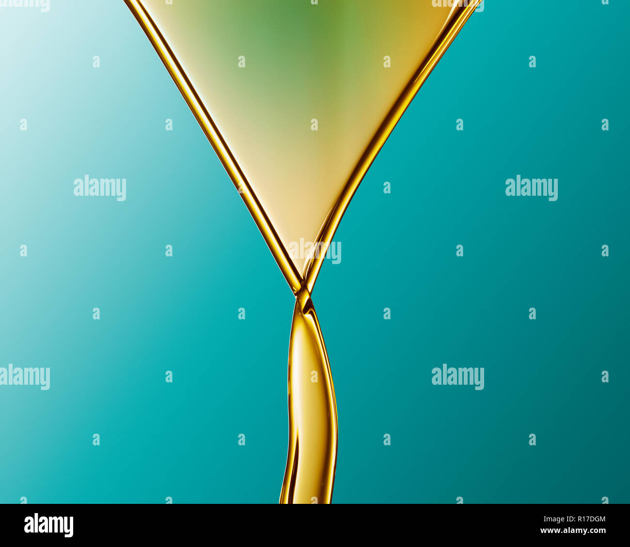 Golden coloured oil flowing into V shape and crossing over against blue background Stock Photo
