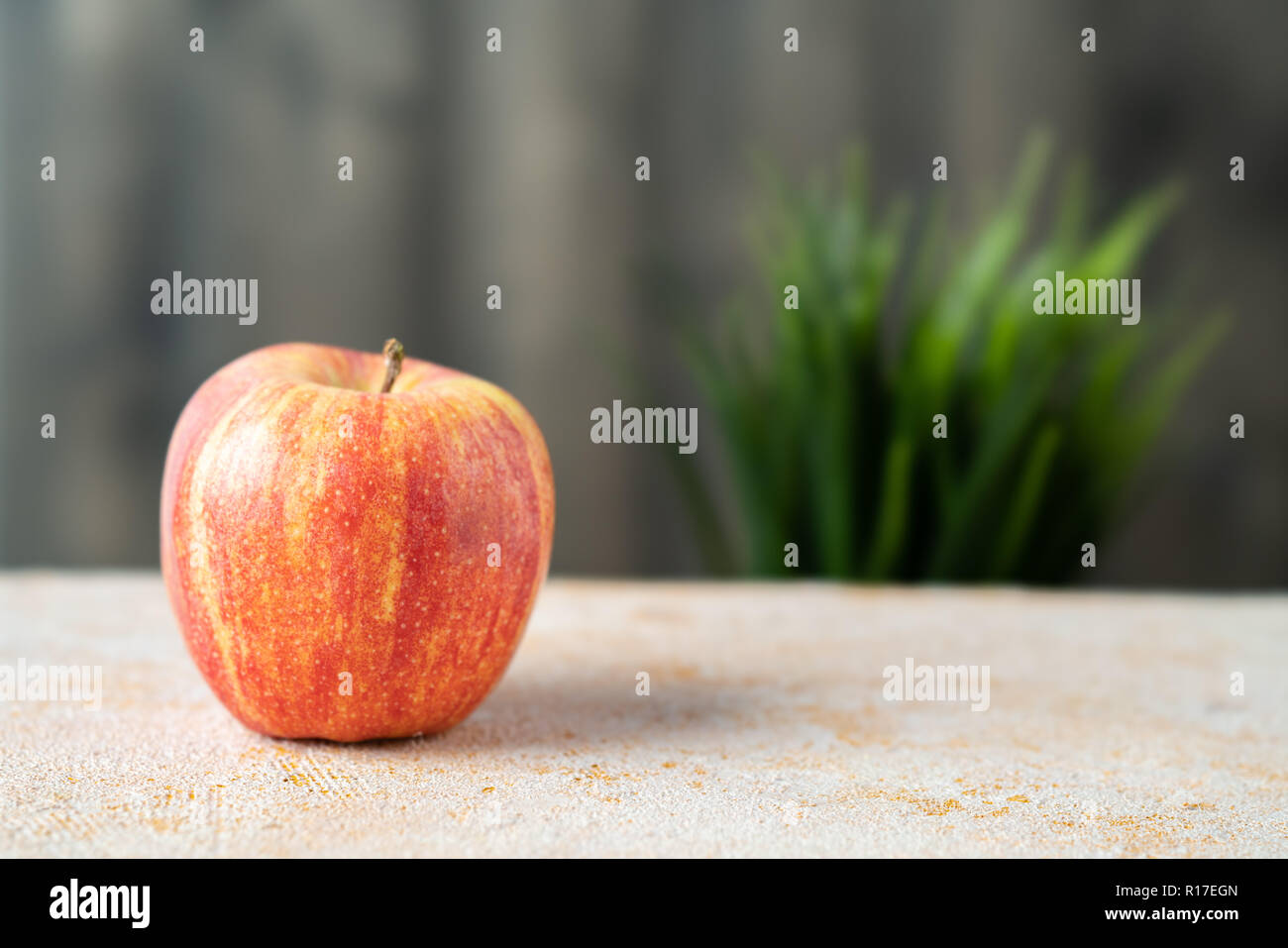 Red apple on textured table Stock Photo