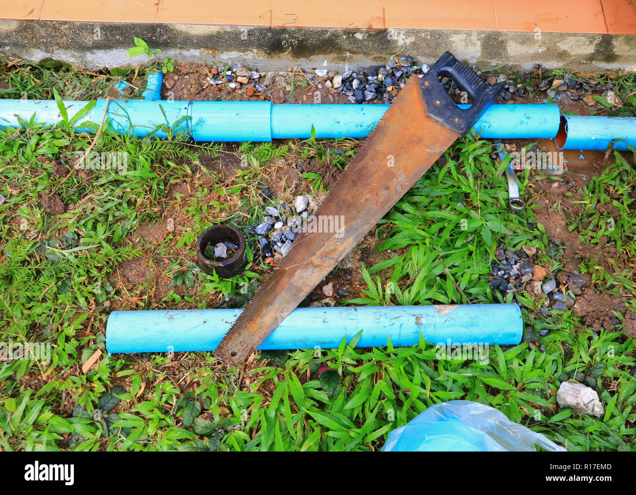 plumber cut with saw repair, plumbing broken pipe Stock Photo - Alamy