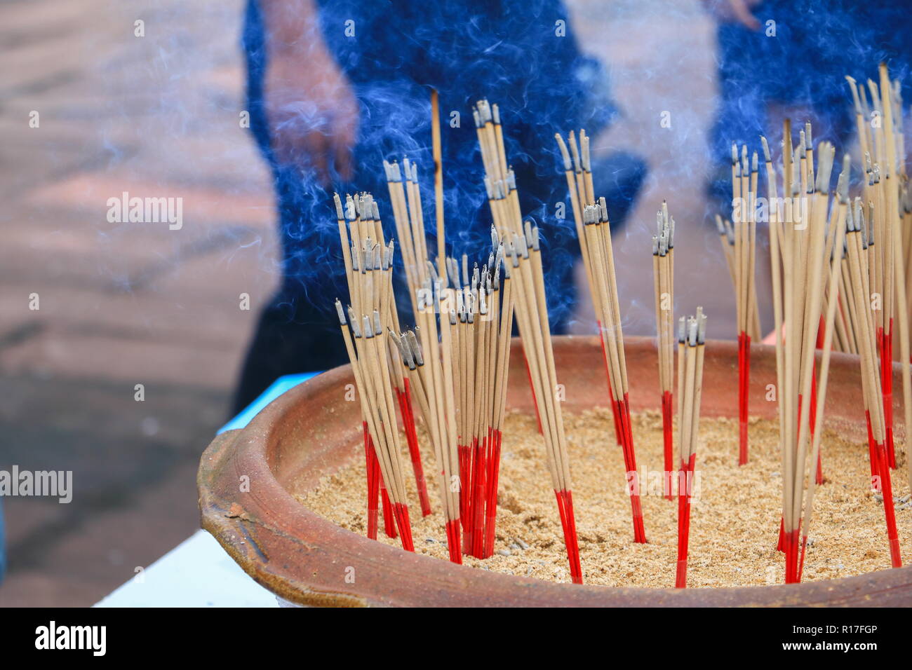 Incense stick burning and smoke in pot Stock Photo Alamy