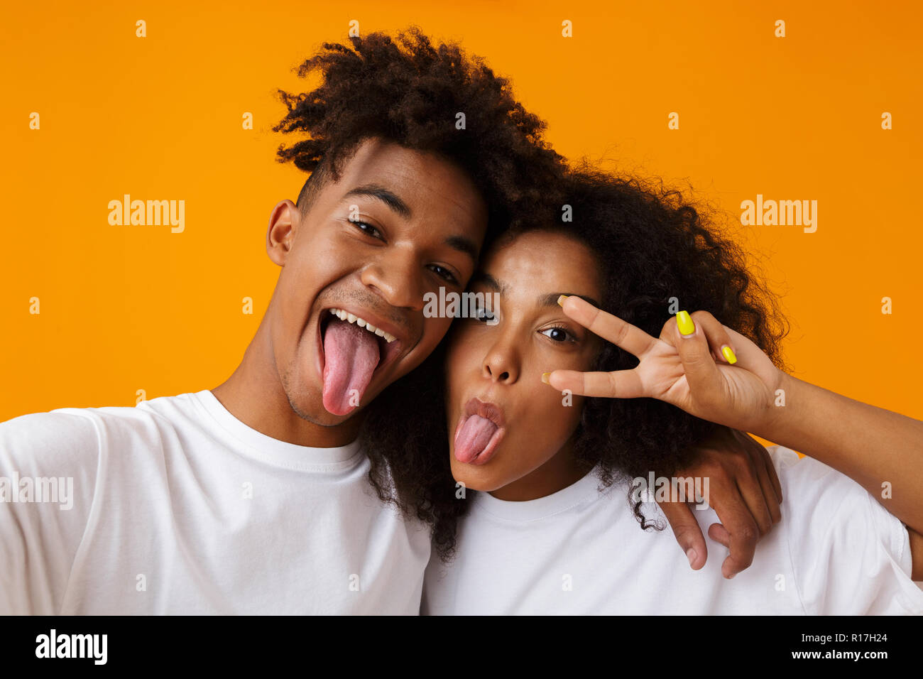 Image of happy young cute african couple posing isolated over beige ...
