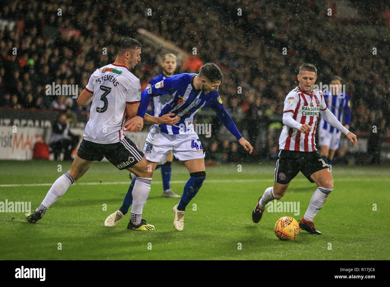 9th November 2018, Bramall Lane, Sheffield, England; Sky Bet Championship, The Steel Derby,  Sheffield United v Sheffield Wednesday ; Matt Penney of Sheffield Wednesday loses the ball to Enda Stevens (03) of Sheffield United and Oliver Norwood (16) of Sheffield United    Credit: Mark Cosgrove/News Images  English Football League images are subject to DataCo Licence Stock Photo