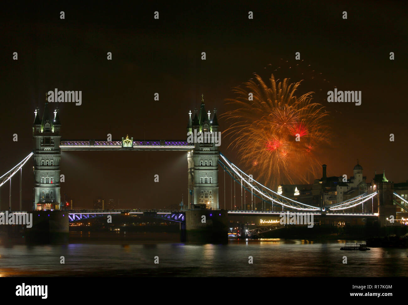 Tower Bridge at night with fireworks in the background, Celebration of Guy Fawkes day in London UK Stock Photo