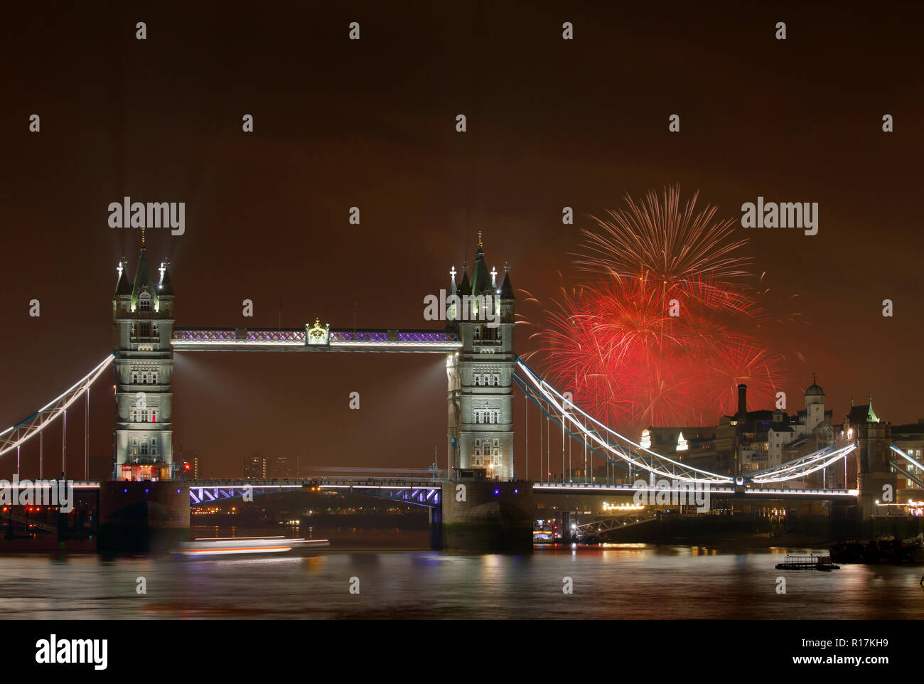 Tower Bridge at night with fireworks in the background, Celebration of Guy Fawkes day in London UK Stock Photo