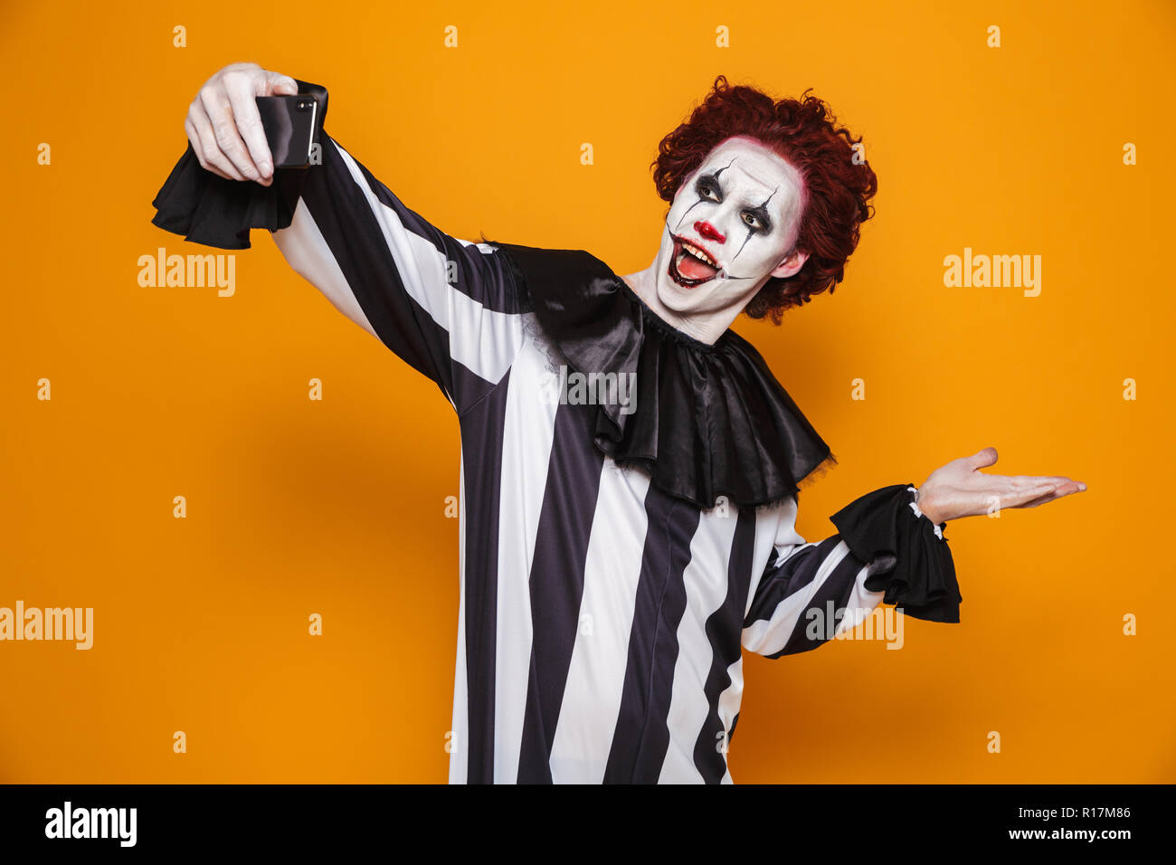 Smiling Scary Man Clown With Red Hair And Scary Make Up Making