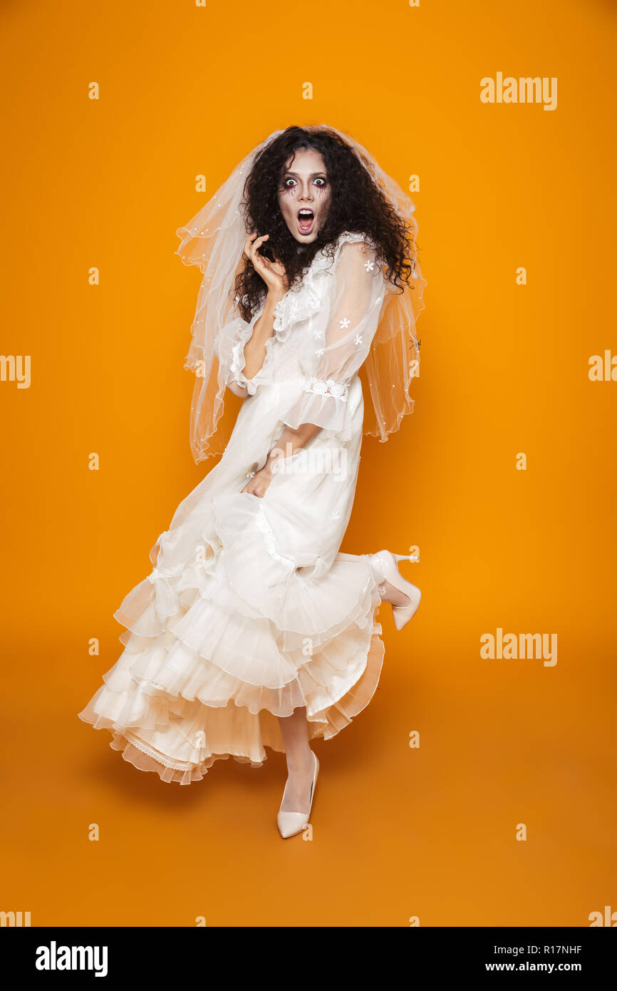 Full Length Shot Of Frightened Creepy Woman Zombie In White