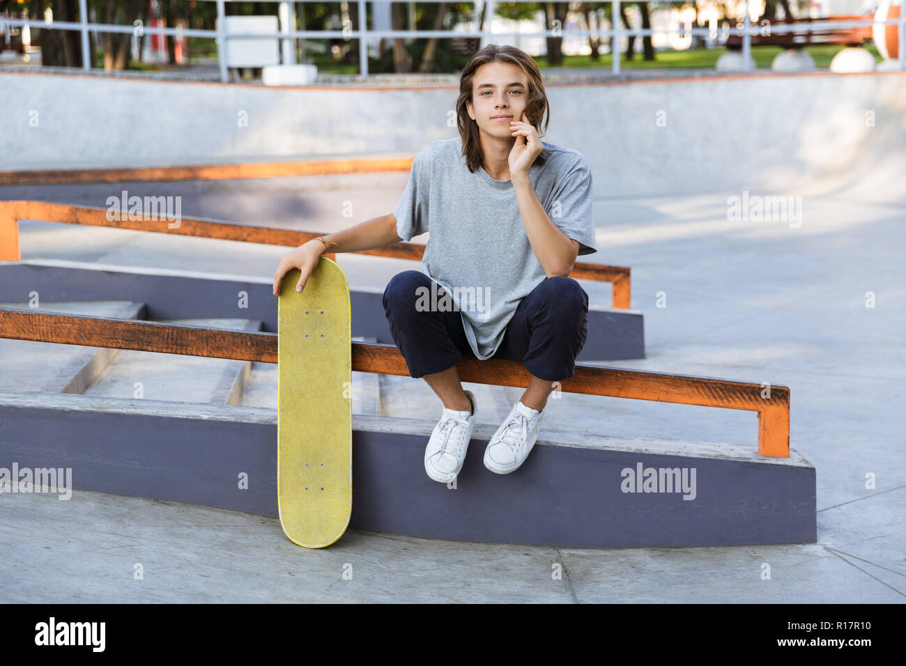 Image of handsome young skater guy sit in the park with skateboard Stock  Photo - Alamy