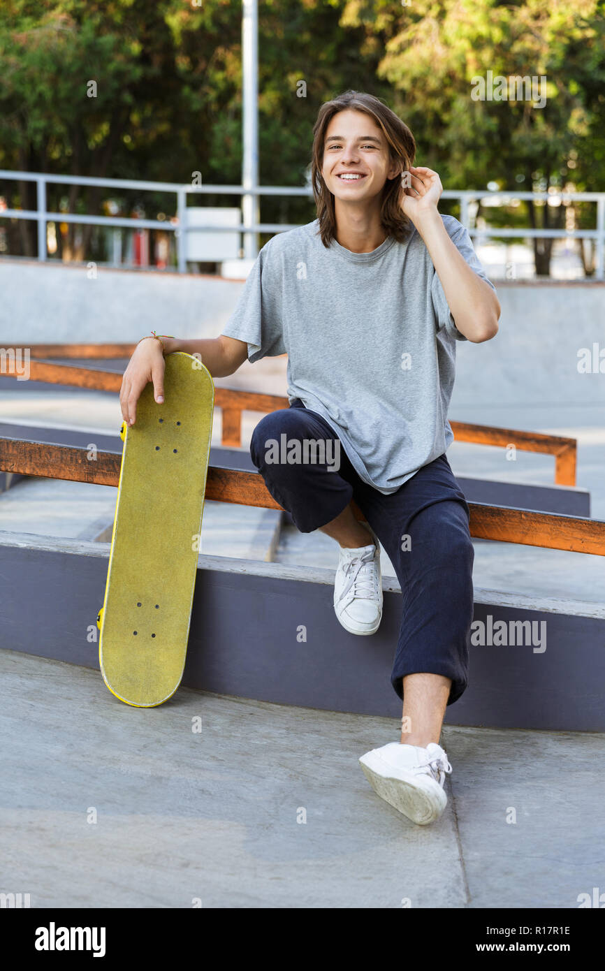 Close Up Young Teenager Boy Wear Street Style Fashion Clothes And Sit Lean  Against On Cement Wall Background Near Skateboard At Public Park For  Lifestyle Concept Stock Photo - Download Image Now 