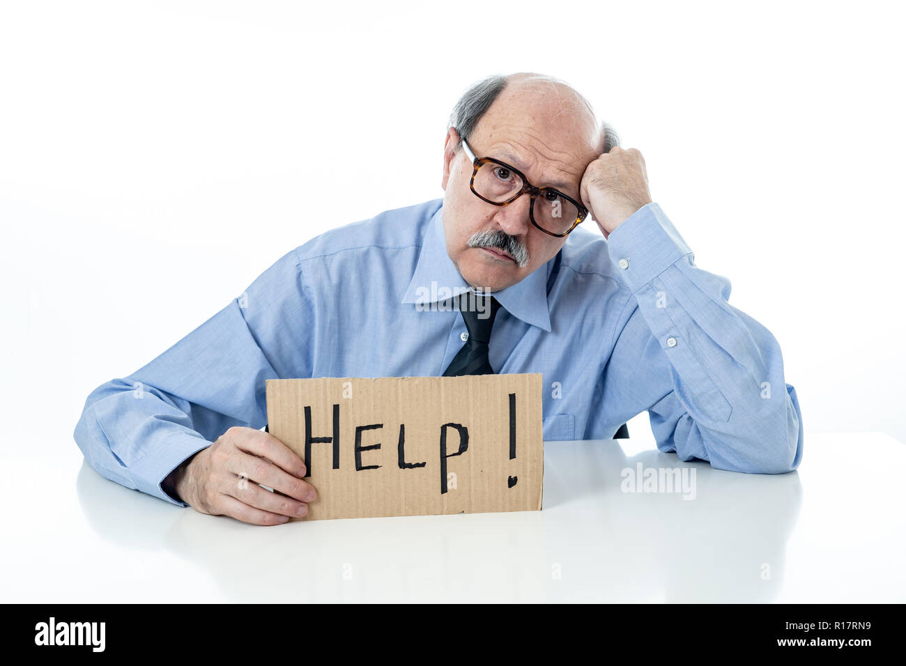 Senior mature business man with bald head on his 60s feeling stressed and frustrated looking tired and overwhelmed holding a help sign in Job problems Stock Photo