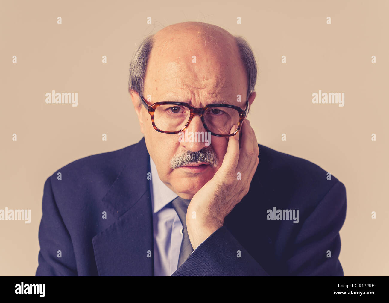 Close up portrait mature bald business man on his 60s feeling sad and worried dementia in Elderly people still working Alzheimer disease Mental diseas Stock Photo