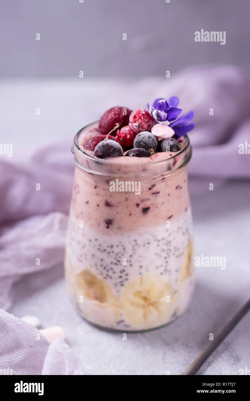 Tasty pudding for breakfast with chia on violet and purple background ...