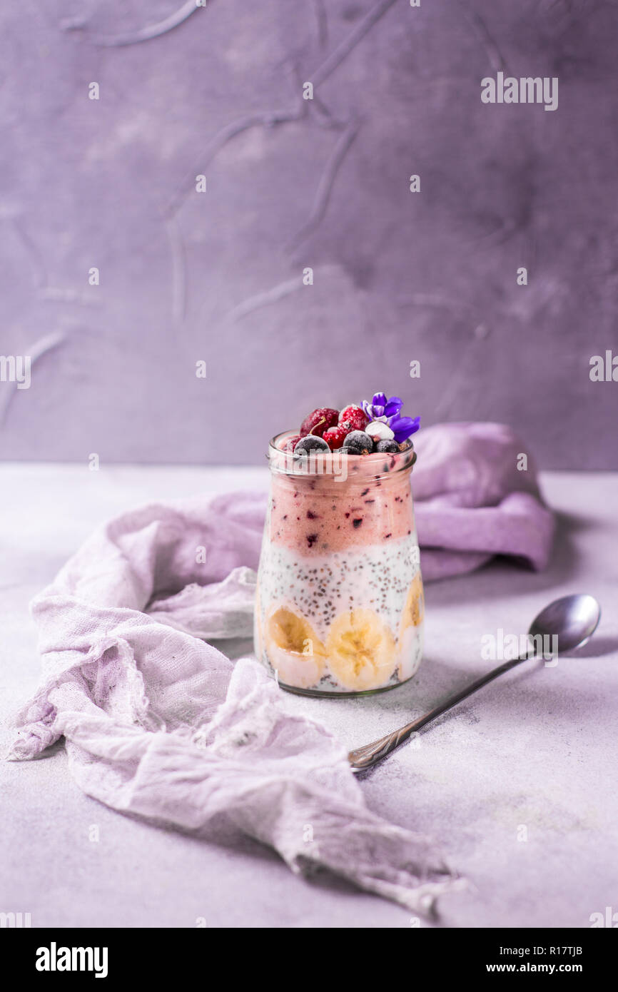 Tasty pudding for breakfast with chia on violet and purple background ...