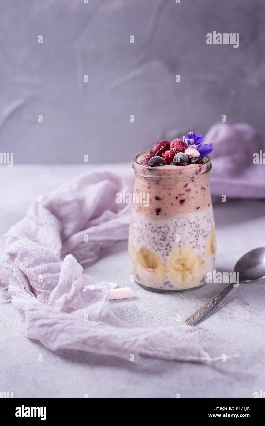 Tasty pudding for breakfast with chia on violet and purple background ...