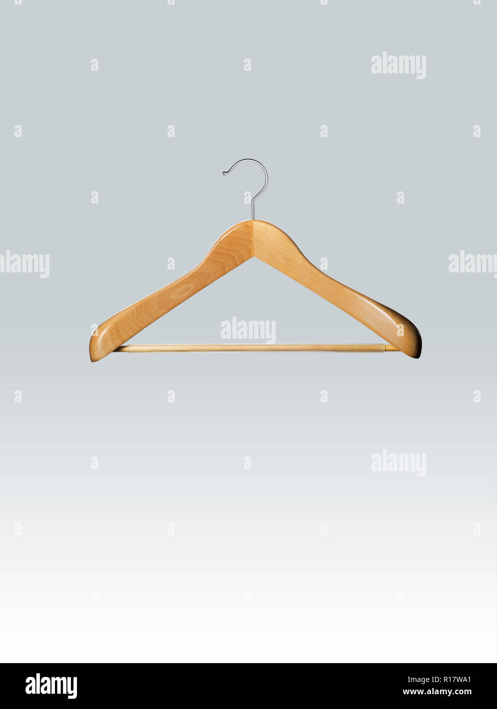 Empty wooden clothes hanger in mid air, grey background Stock Photo