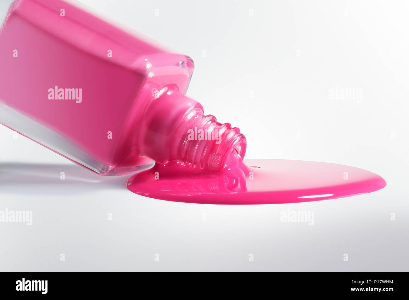 Pink nail polish forming puddle on white background, close up Stock Photo