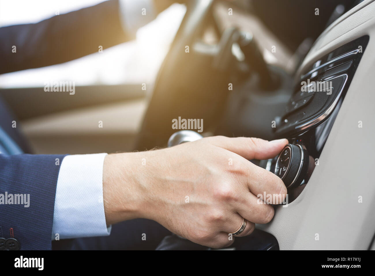 the man presses the buttons in the car in the bright mozannom salon ...