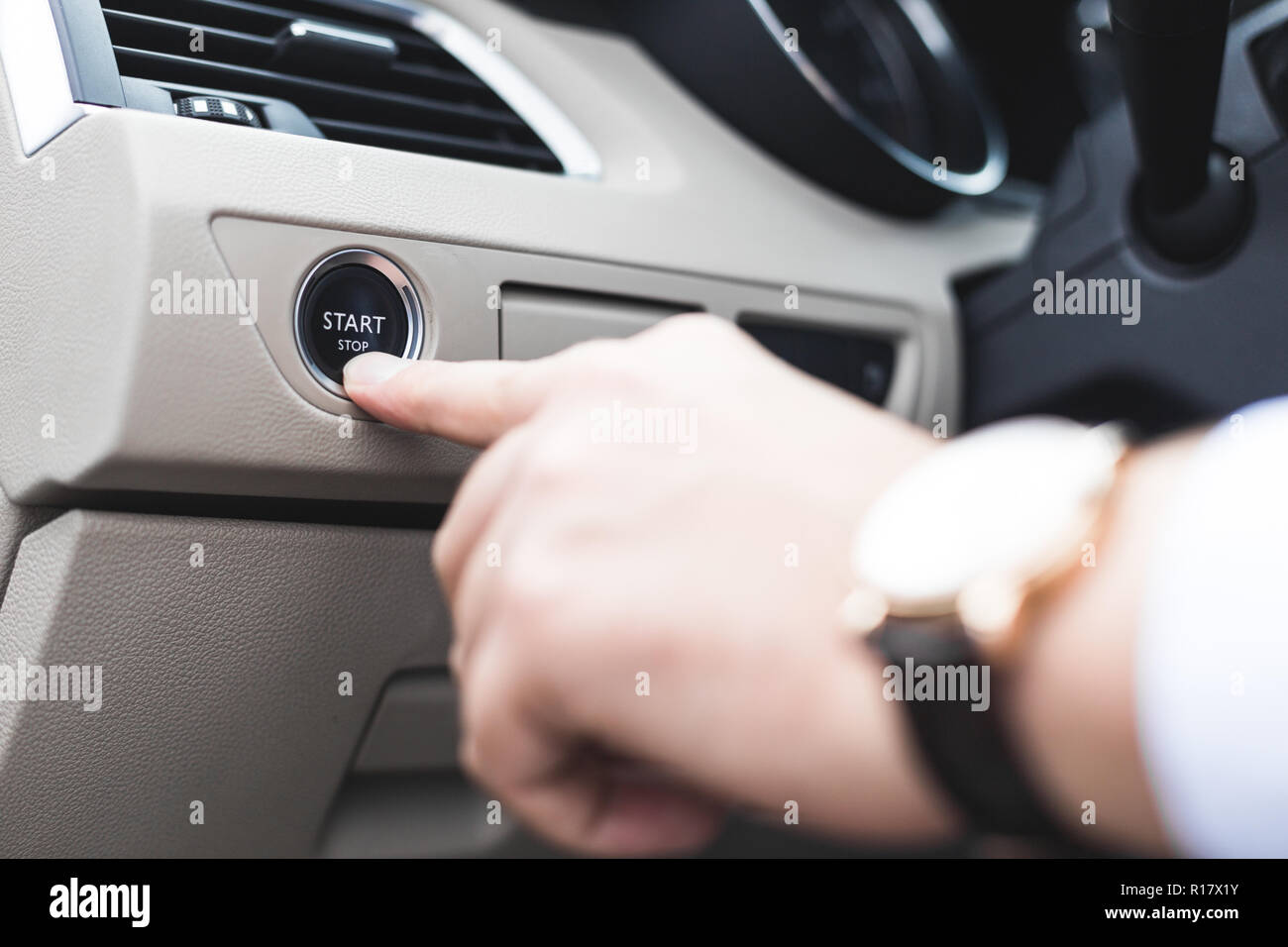 Car start stop system with finger pressing the button, horizontal image Stock Photo
