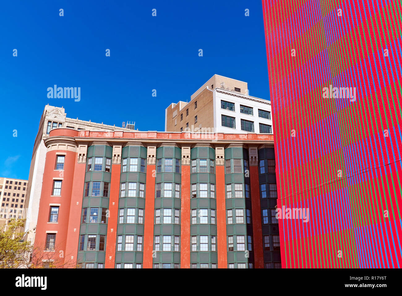 Signs of the downtown Cleveland renaissance include the fusion-colored painted wall of Wilton Manor Apts to flat iron shaped Osborn apartment building Stock Photo