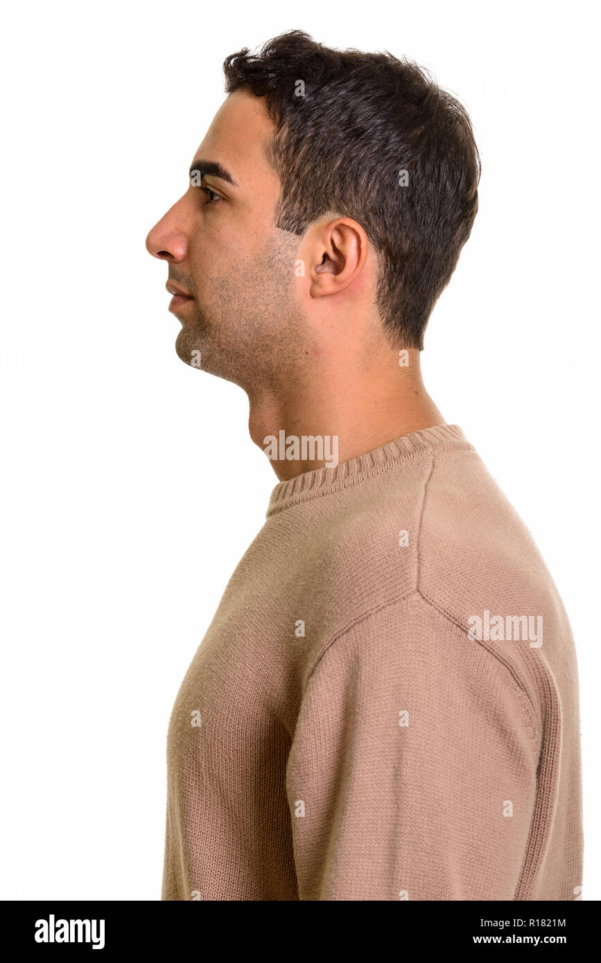 Profile view of young handsome Persian man standing Stock Photo