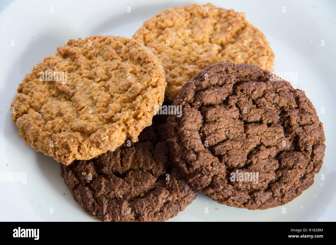 Chocolate and ginger biscuits on a white plate Stock Photo