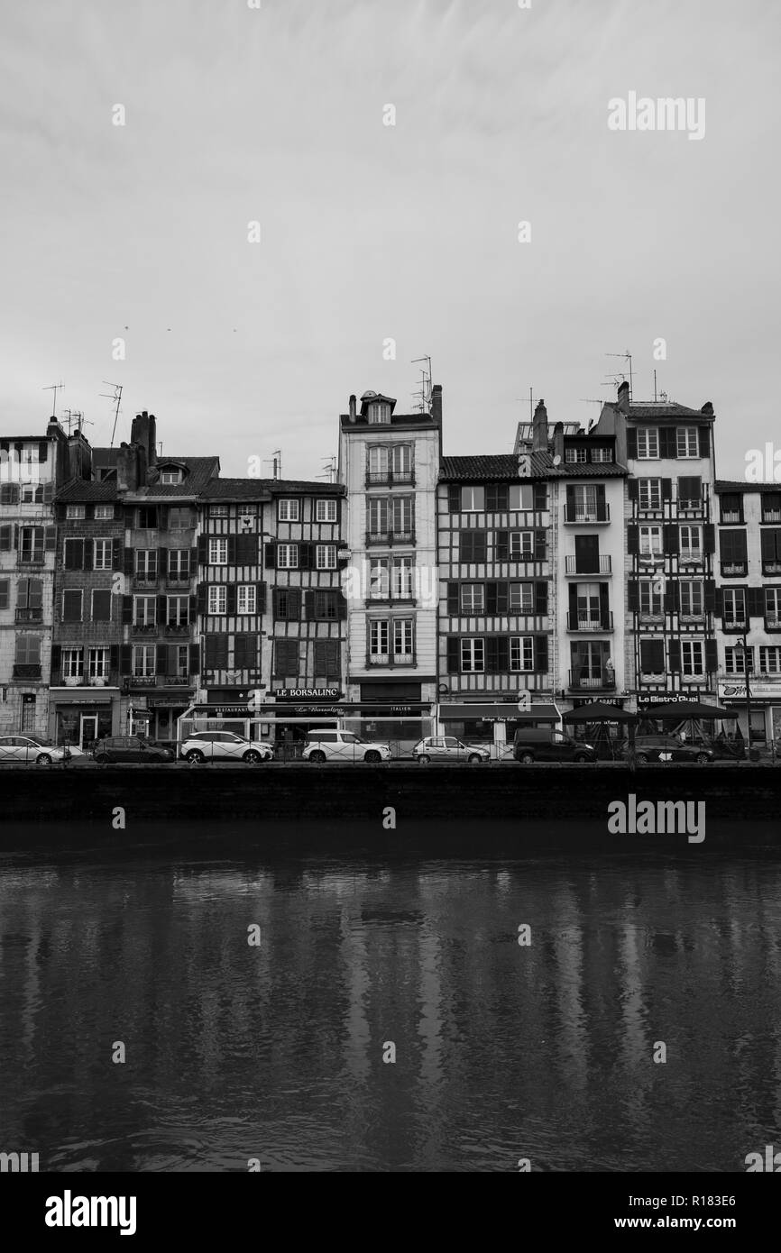 Old buildings lining a river in Bayonne, France. Stock Photo