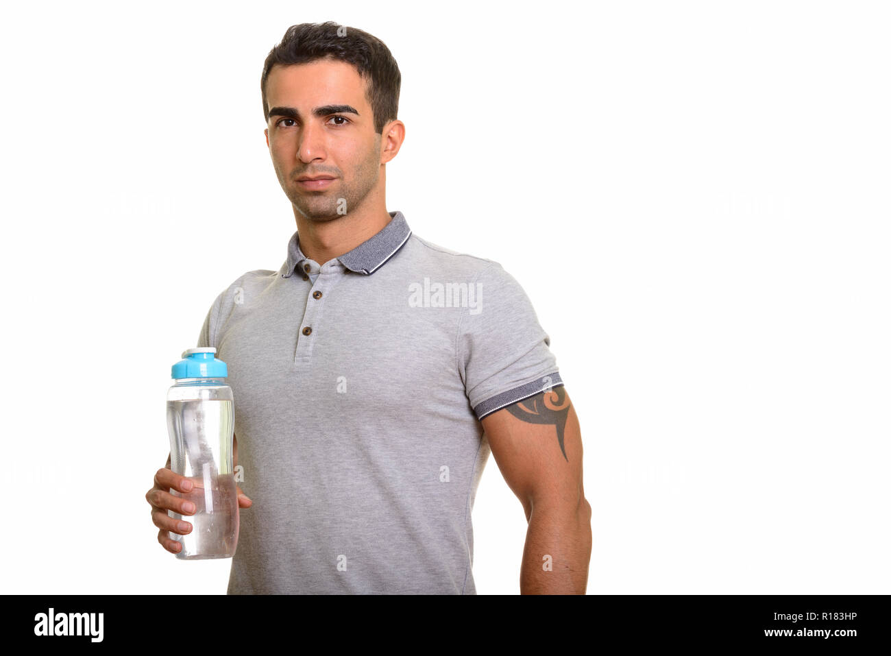 Portrait of young handsome Persian man holding water bottle Stock Photo ...