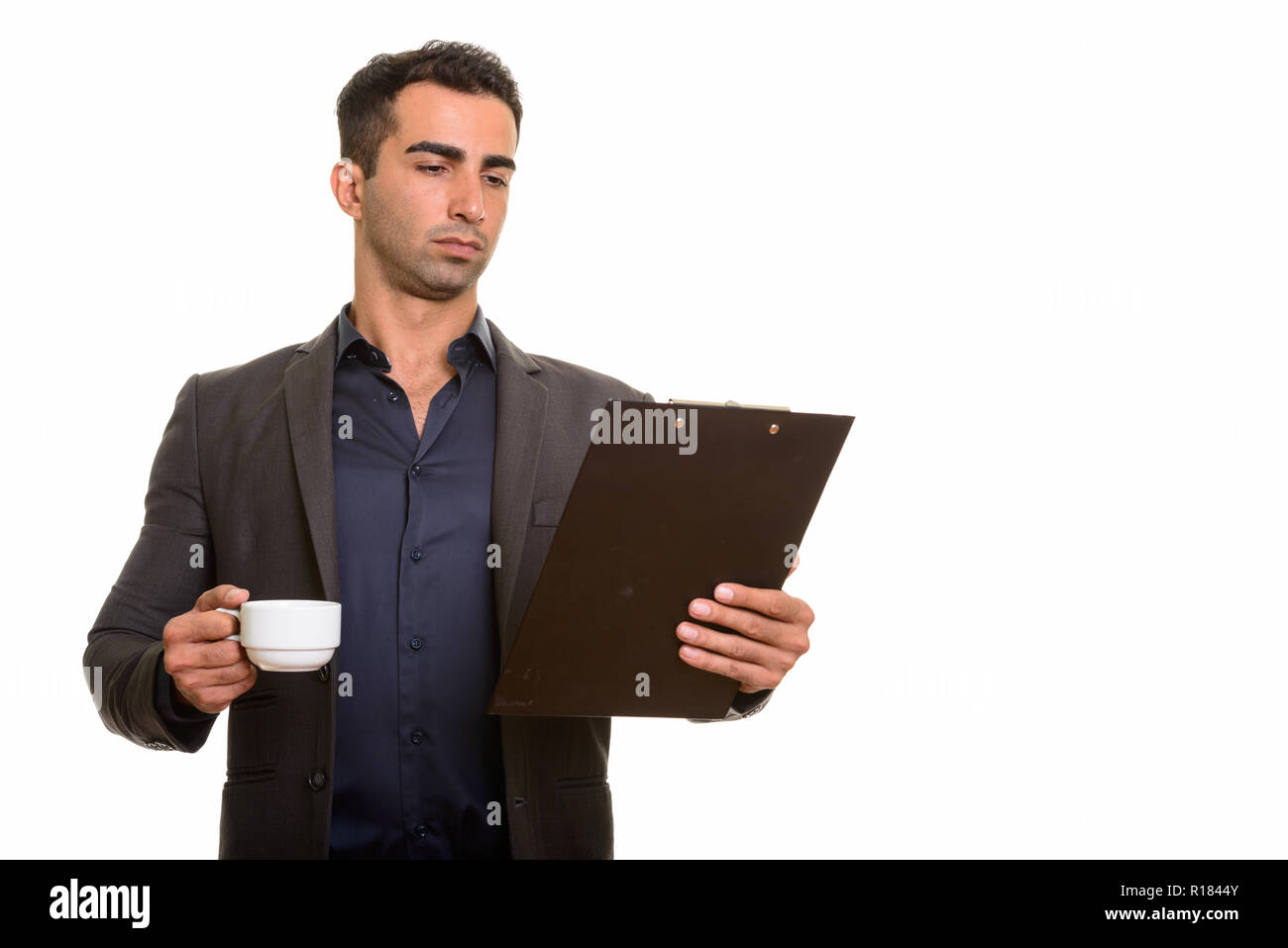 Persian businessman with clipboard and coffee cup Stock Photo