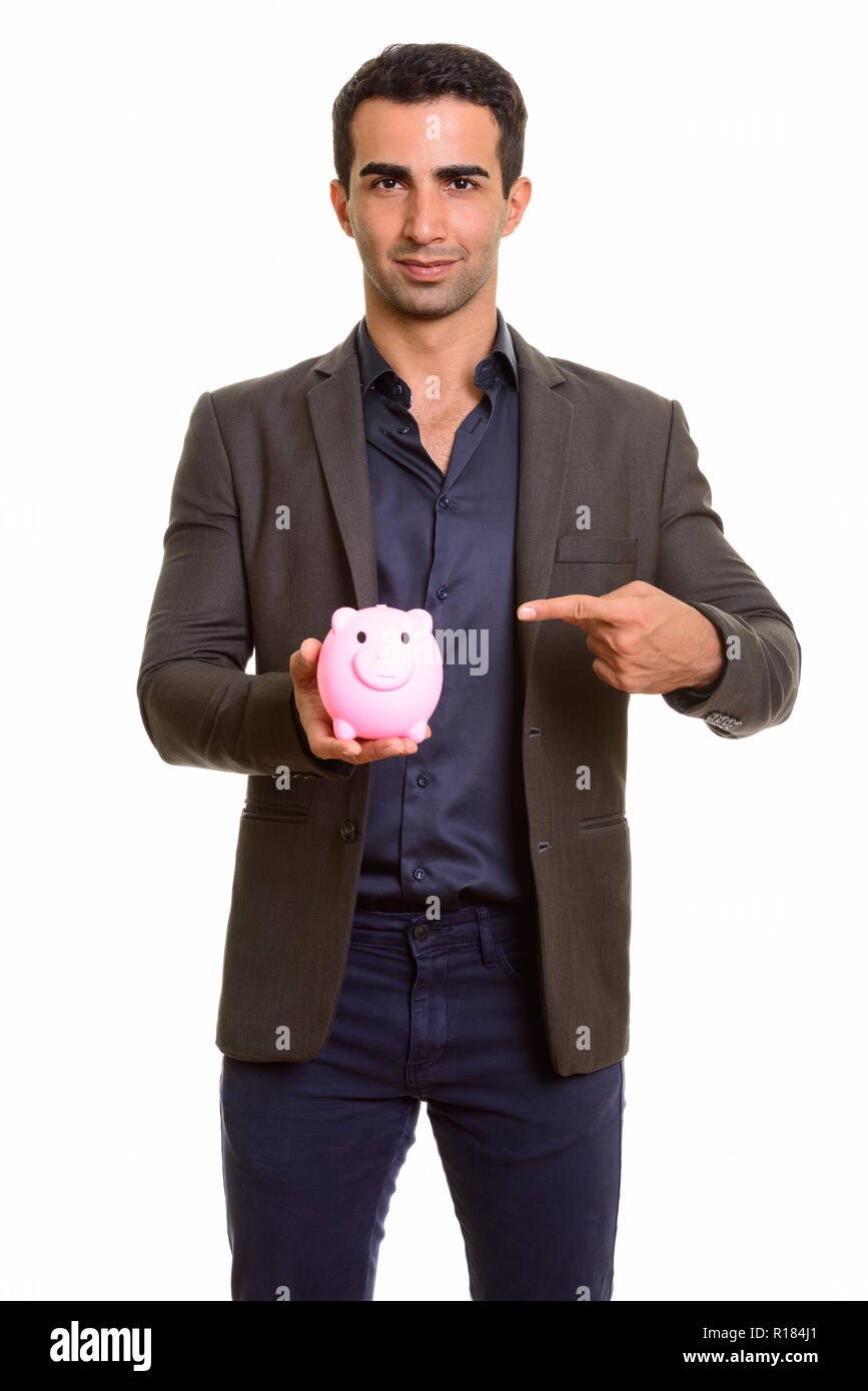 Persian businessman holding piggy bank against white background Stock Photo