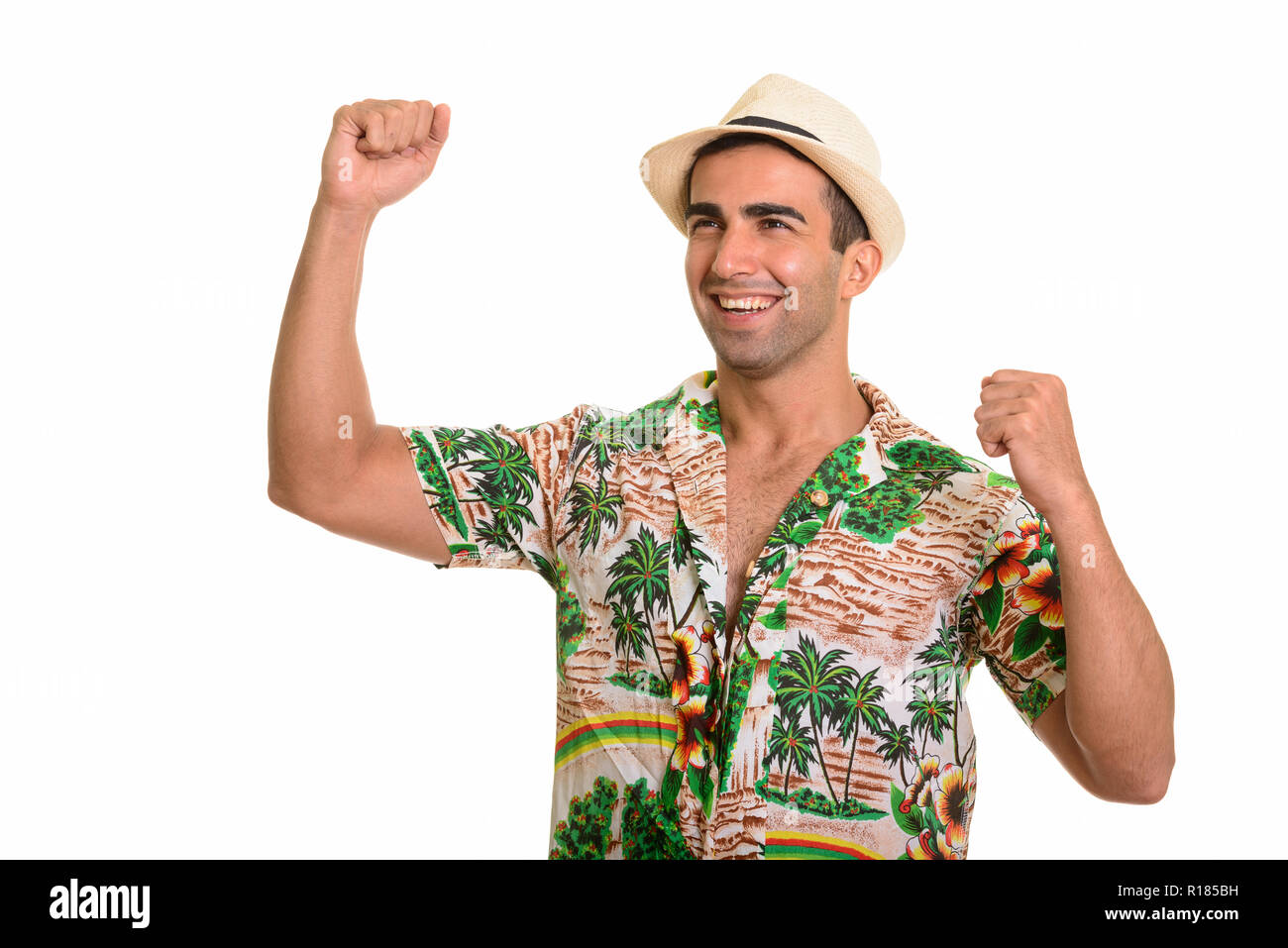 Portrait of young handsome Persian tourist man looking happy Stock Photo