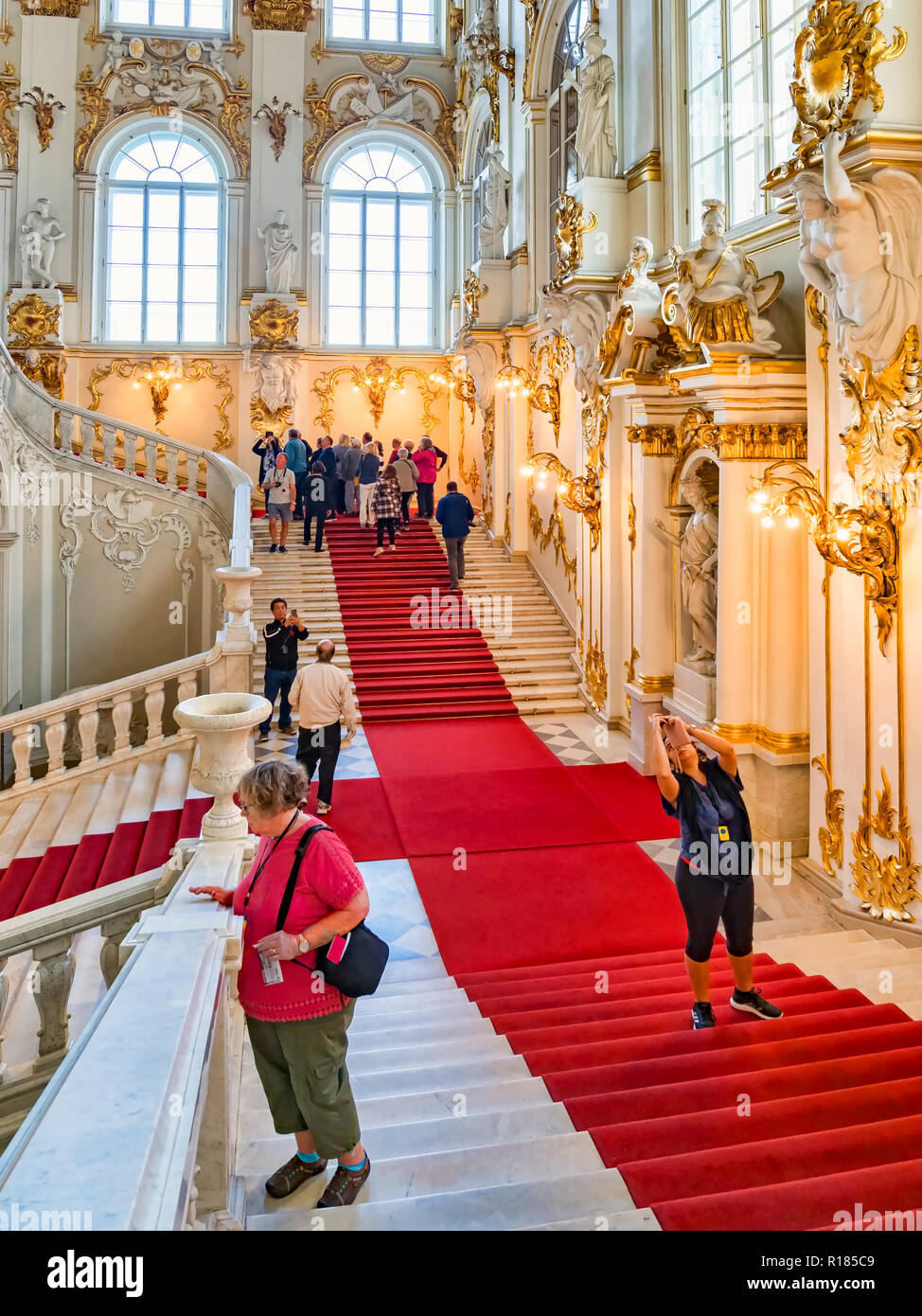 19 September 2018: St Petersburg, Russia - Tour parties on the main stairs of the Hermitage Museum. Stock Photo