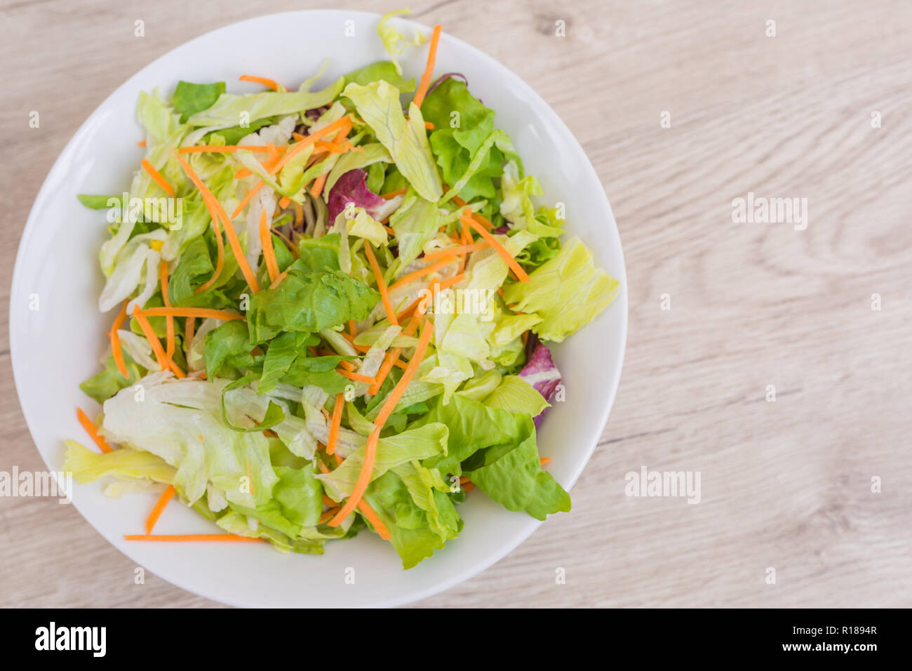 Fresh Vegetable salad on old wooden table. Vegan meal plate on wooden table top Stock Photo