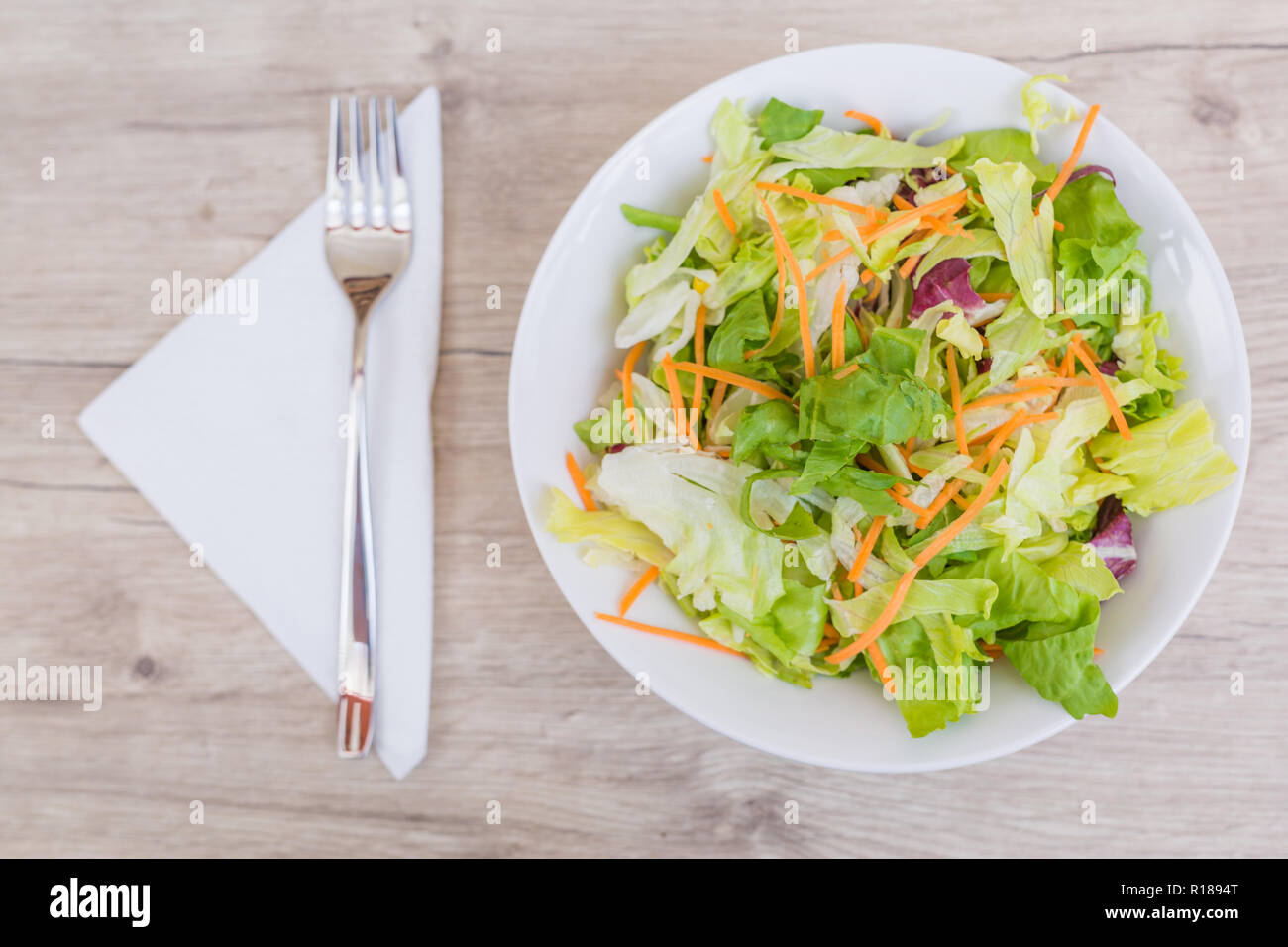 Fresh Vegetable salad on old wooden table. Vegan meal plate on wooden table top Stock Photo