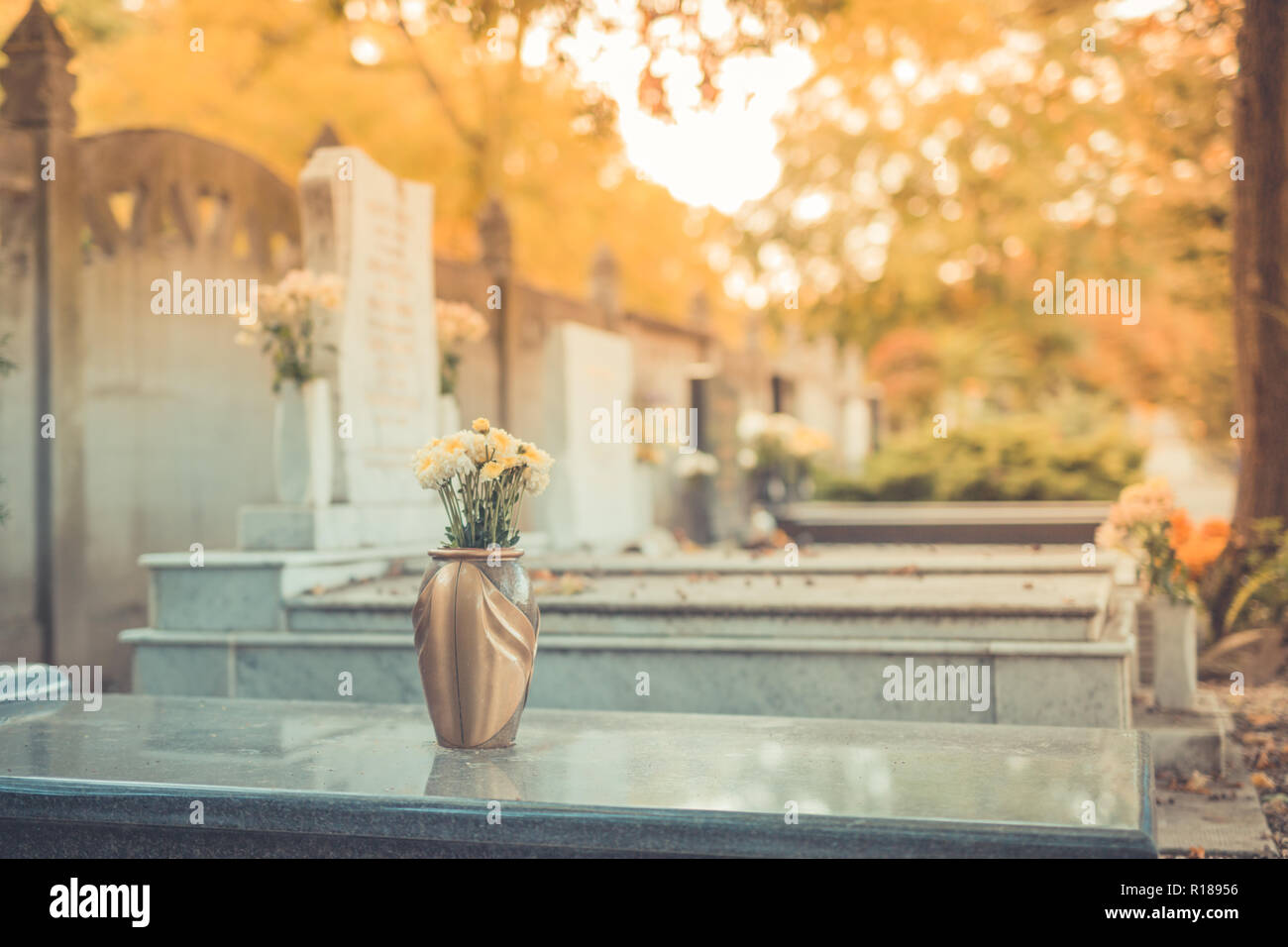 Graves with grave stones at a cemetery in autumn. Memorial day Stock Photo