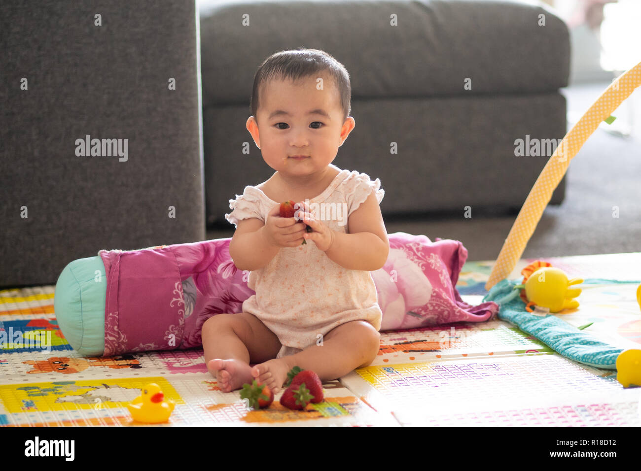 Cute 6 month old baby with strawberries Stock Photo Alamy