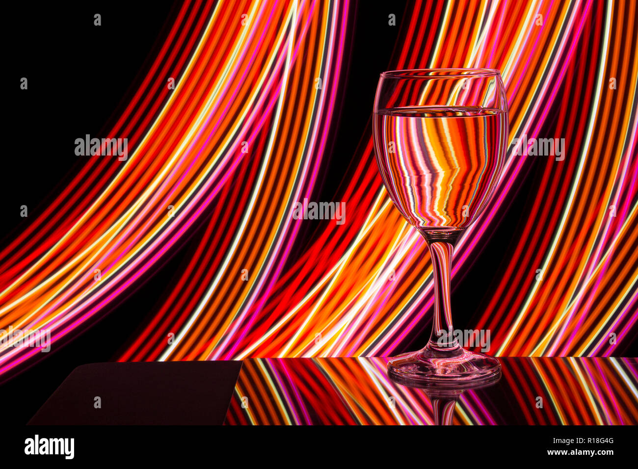 Wine glass / glasses on a black background with neon light painting Stock Photo