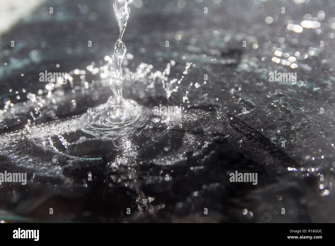 squirt, splash of water on a black background, drops Stock Photo - Alamy