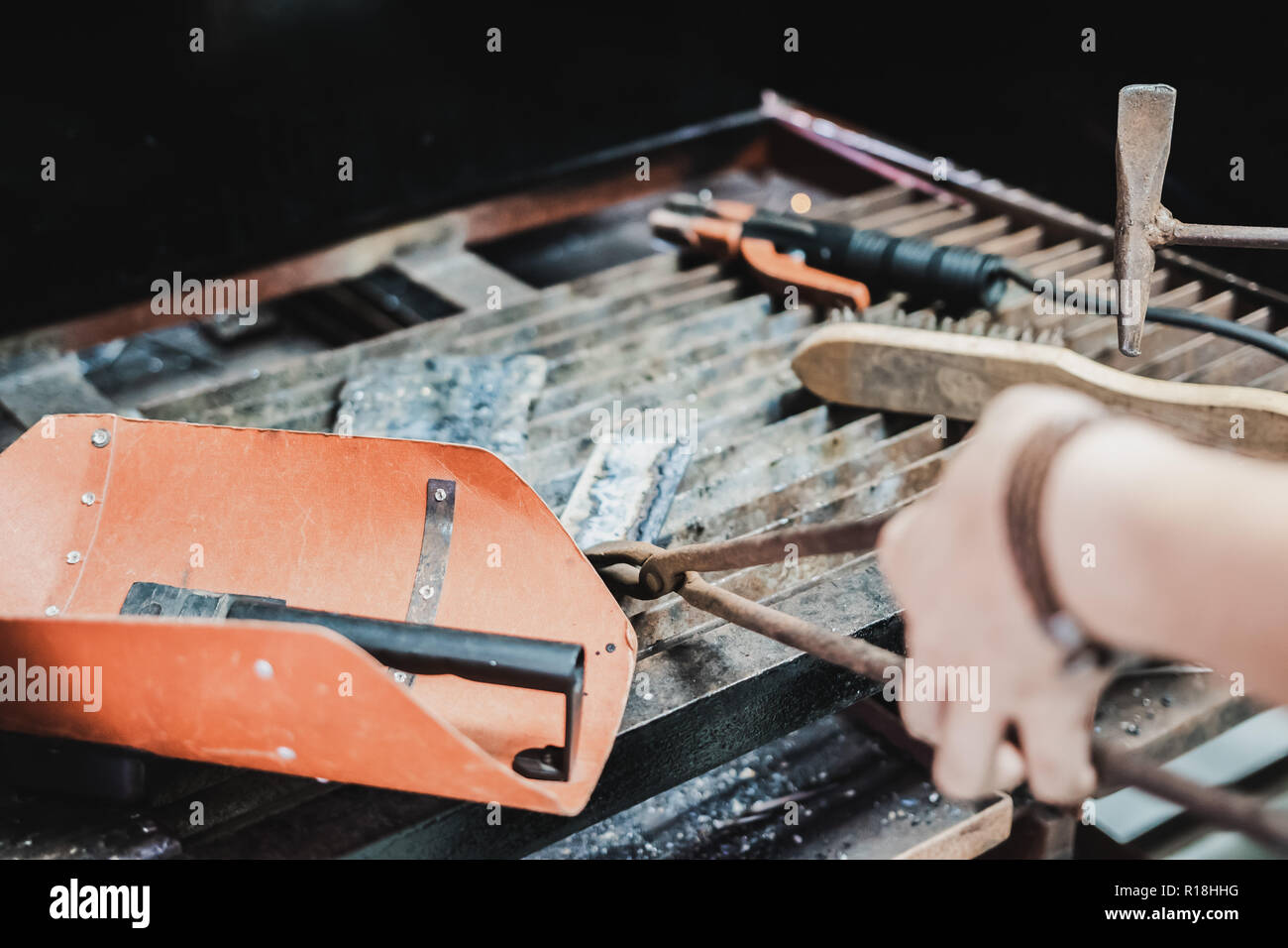 Asian engineering student doing metal work in class using