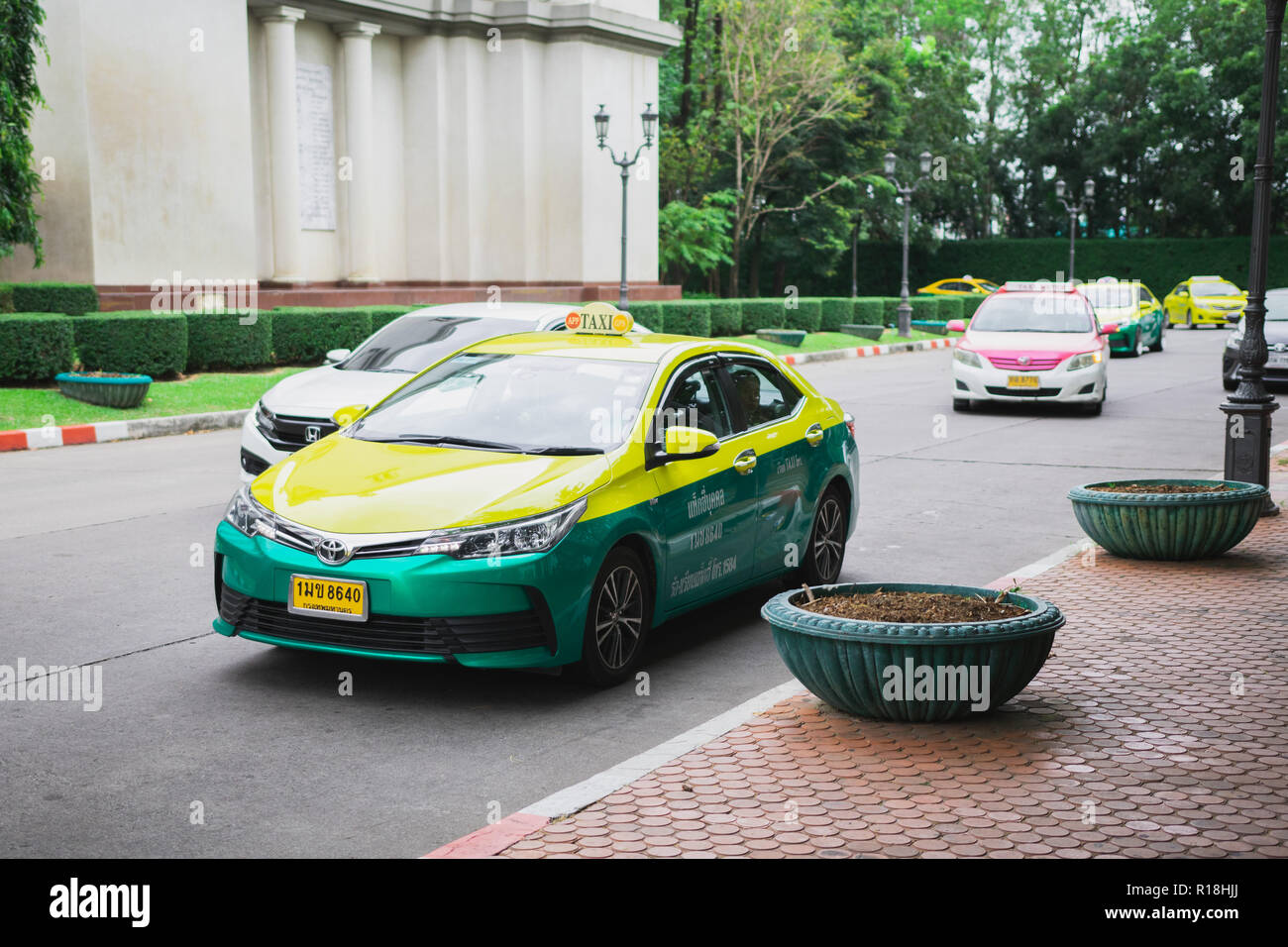 Samut Prakan, Thailand - November 9th, 2018: Thai Taxi driving on street in a private university Stock Photo