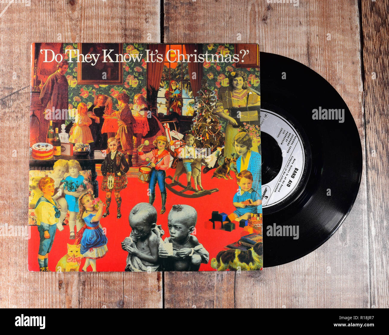 Band Aid 7inch single, 'Do they Know It's Christmas' Record on a wooden background produced to raise money for anti-poverty in Ethiopia 1984 Stock Photo