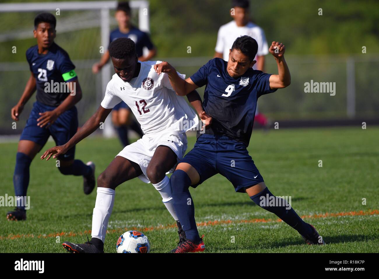 Players compete for possession and control of the ball. Stock Photo