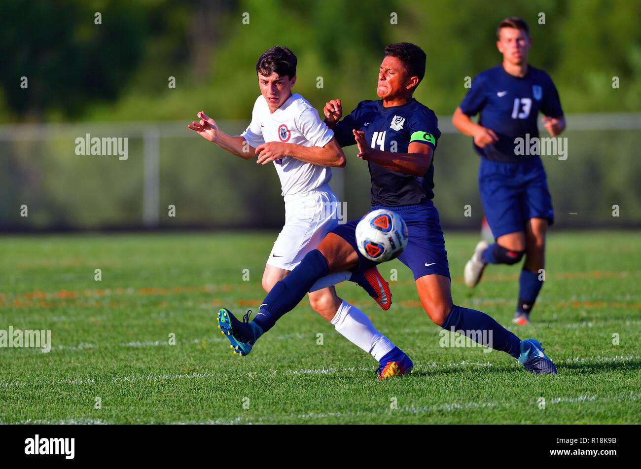 Players battling for possession of the ball during a physical confrontation and exchange. USA. Stock Photo