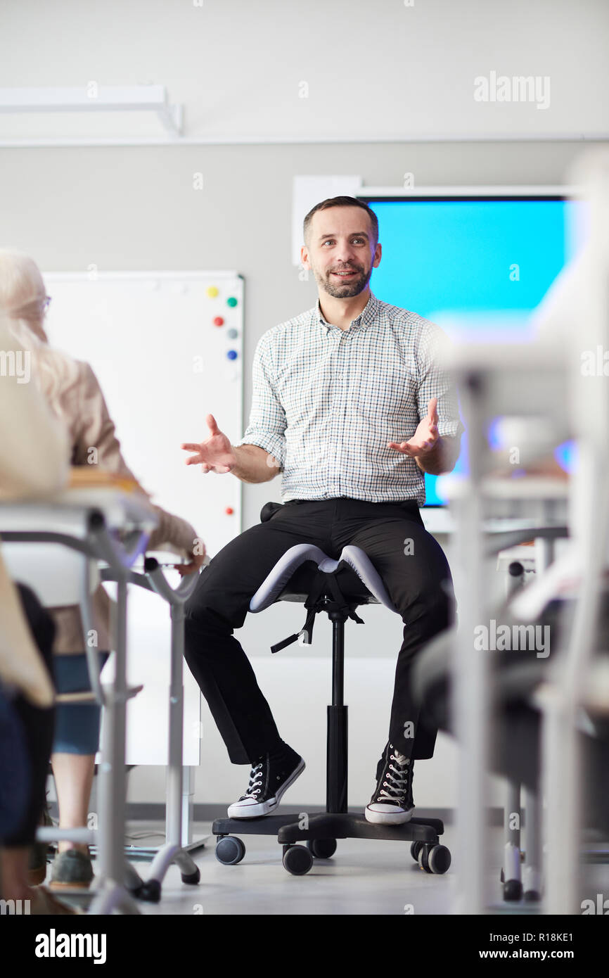 Young teacher explaining to his audience the main points of new topic ...