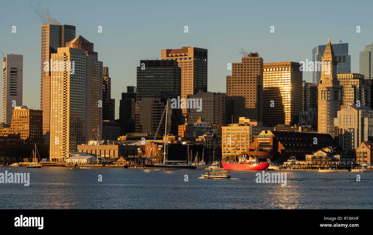 Light reflects of the glass in buildings in the urban downtown city center core skyline of Boston MA Stock Photo