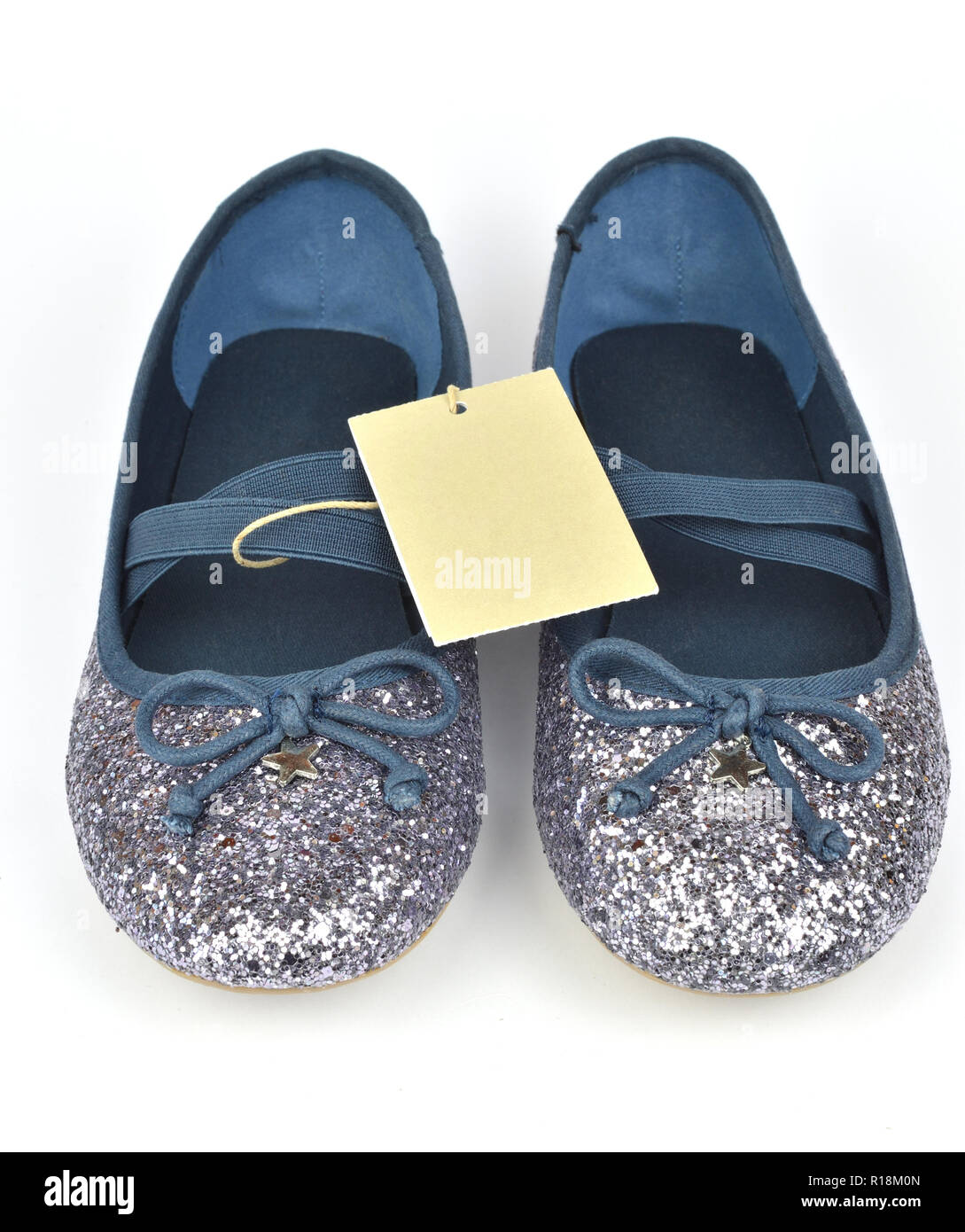 Comfy shimmer silver blue ballerina flat shoes with crossed elastic  drawstrings and a price tag isolated on white Stock Photo - Alamy