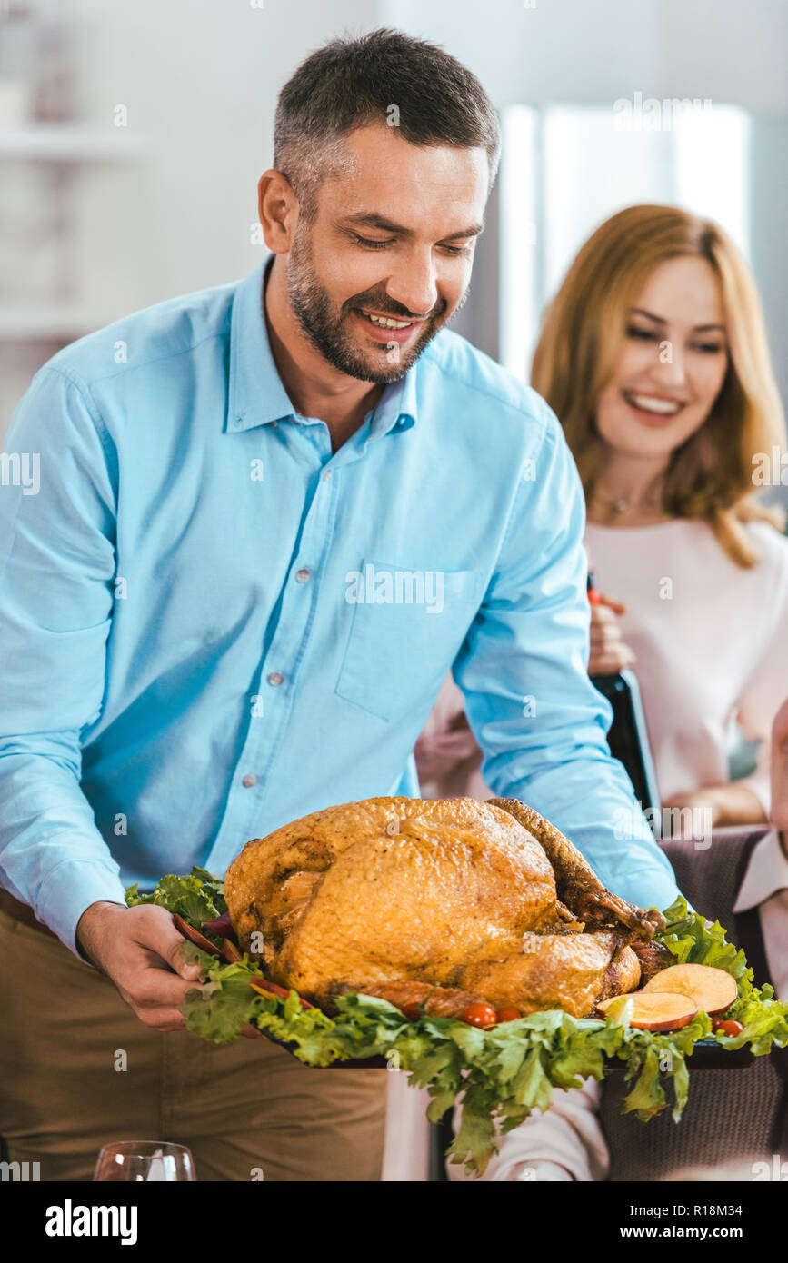 happy young man serving turkey on thanksgiving table Stock Photo